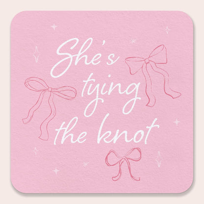 25 Ct She's Tying The Knot Drink Coasters, 4-Inch Disposable Square Paper Coasters for Pink Bows Bridal and Bachelorette Party, Funny Cocktail Table Decor for Bar Drinks