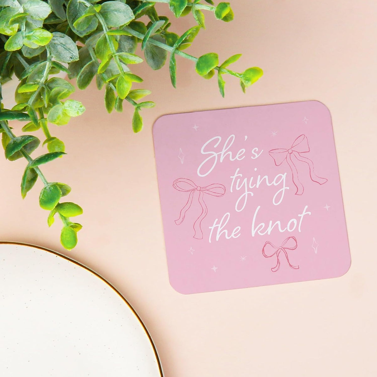 25 Ct She's Tying The Knot Drink Coasters, 4-Inch Disposable Square Paper Coasters for Pink Bows Bridal and Bachelorette Party, Funny Cocktail Table Decor for Bar Drinks